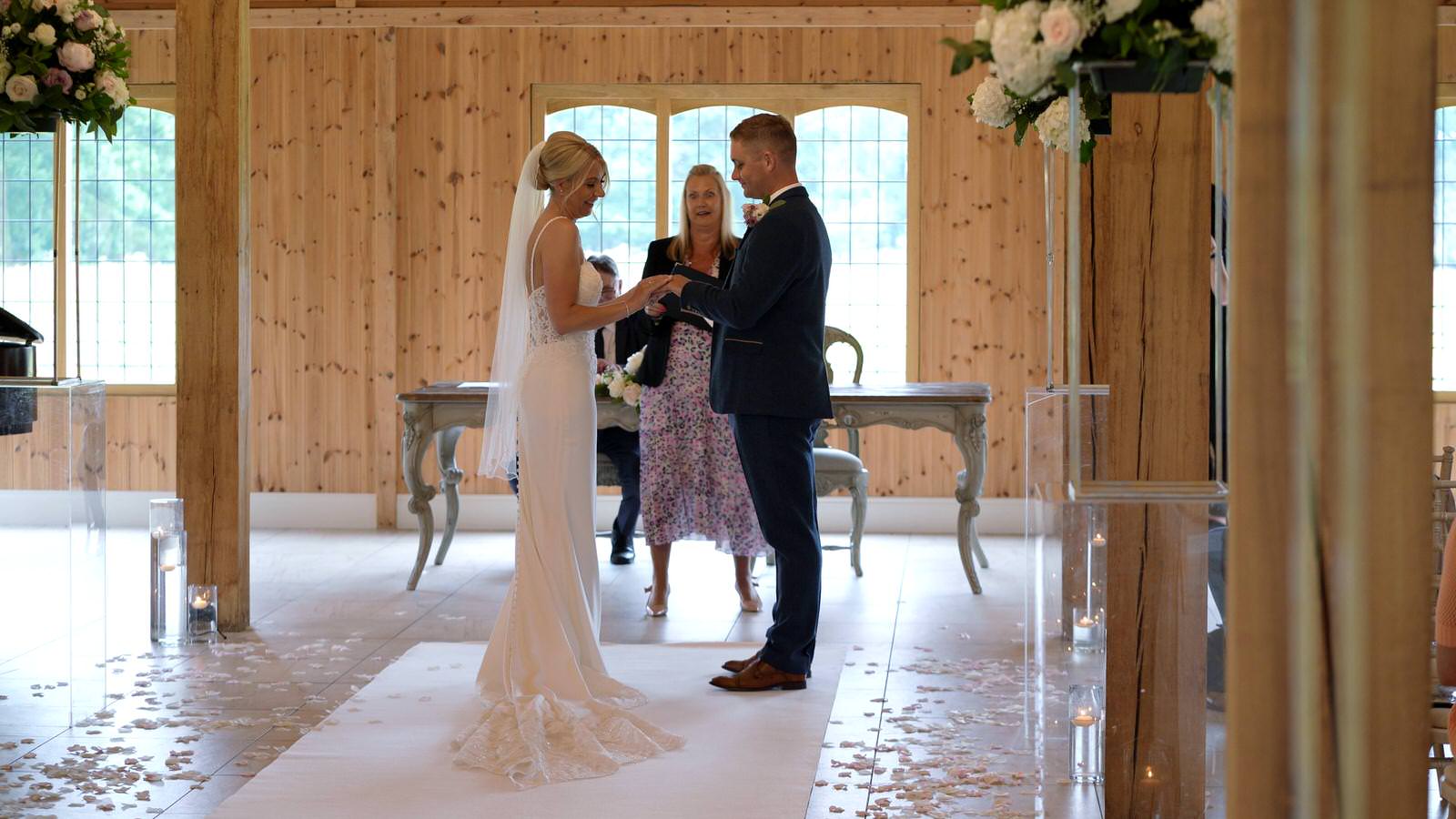 couple exchange rings during ceremony at Merrydale
