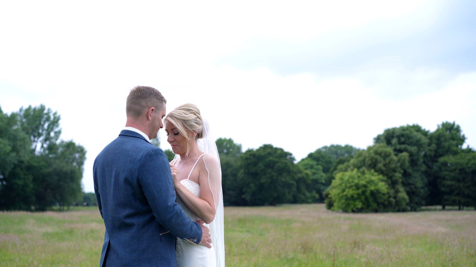 couple pose in the fields by Merrydale manor