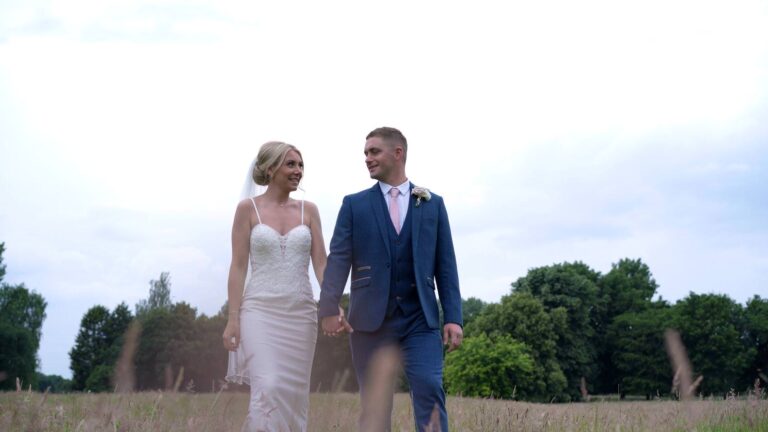 videographer films couple walking through merrydale manor gardens