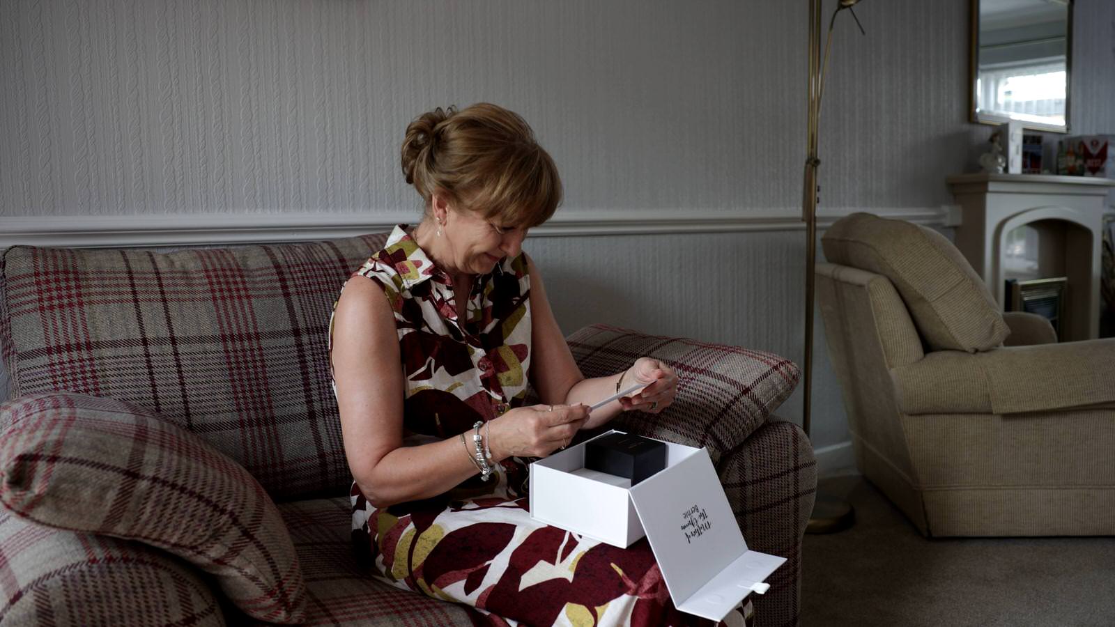 mother of the groom gets emotional opening gift
