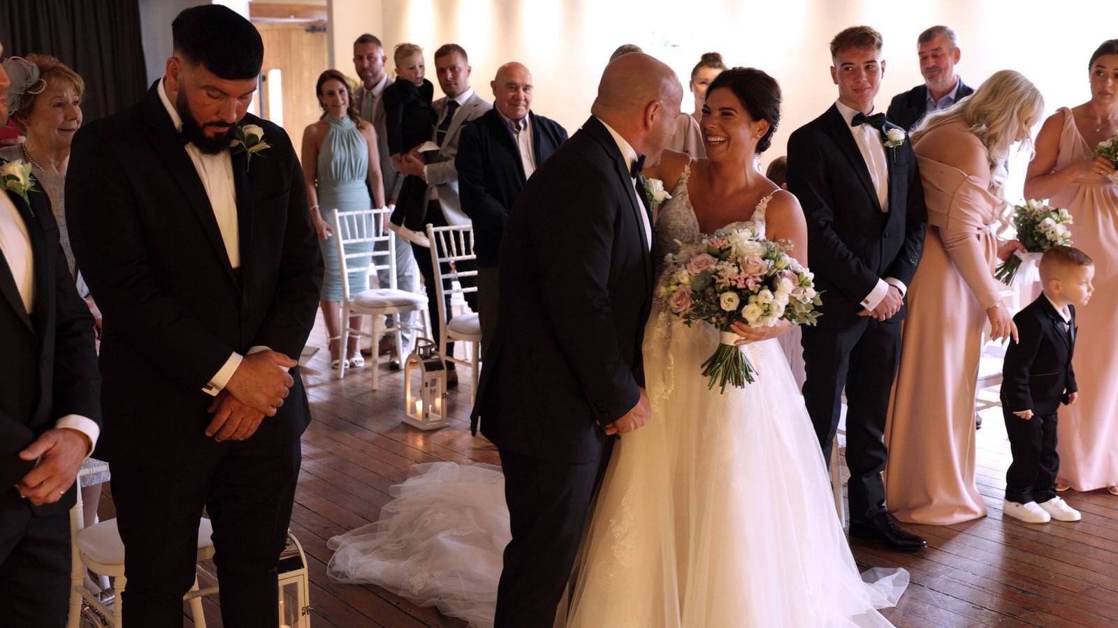 couple laugh during wedding ceremony at The Castlefield Rooms Manchester
