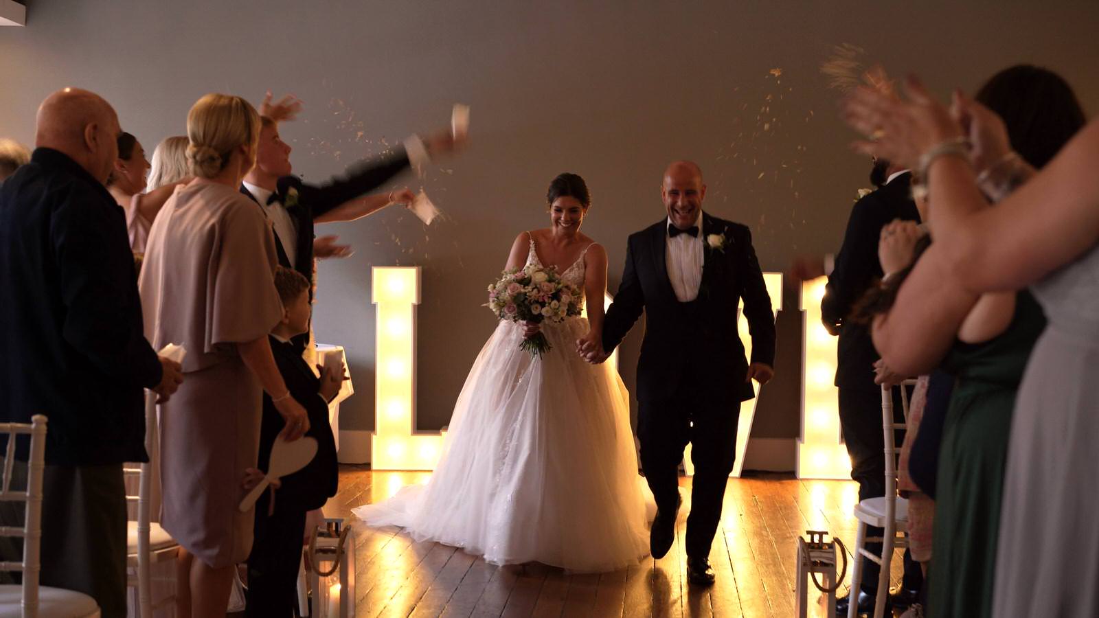 confetti is thrown indoors after ceremony at The Castlefield Rooms Manchester