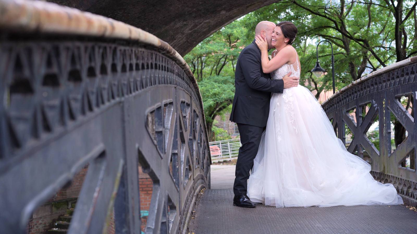 video still of couple laughing on canal bridge near Deansgate