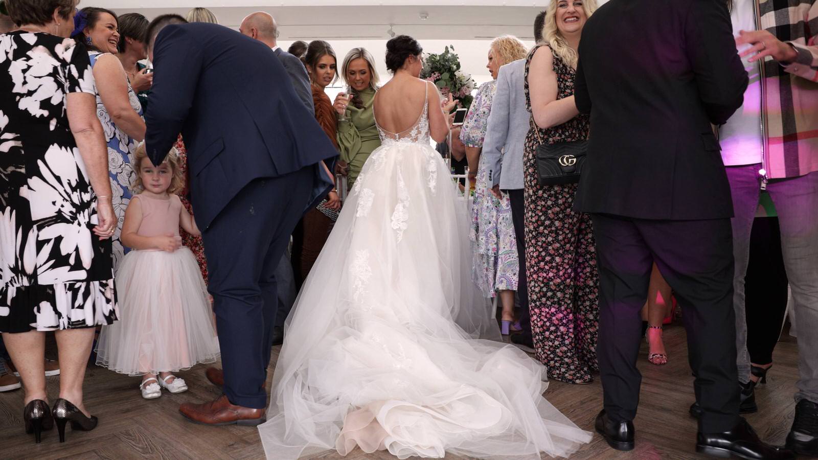 brides big train and guests around it