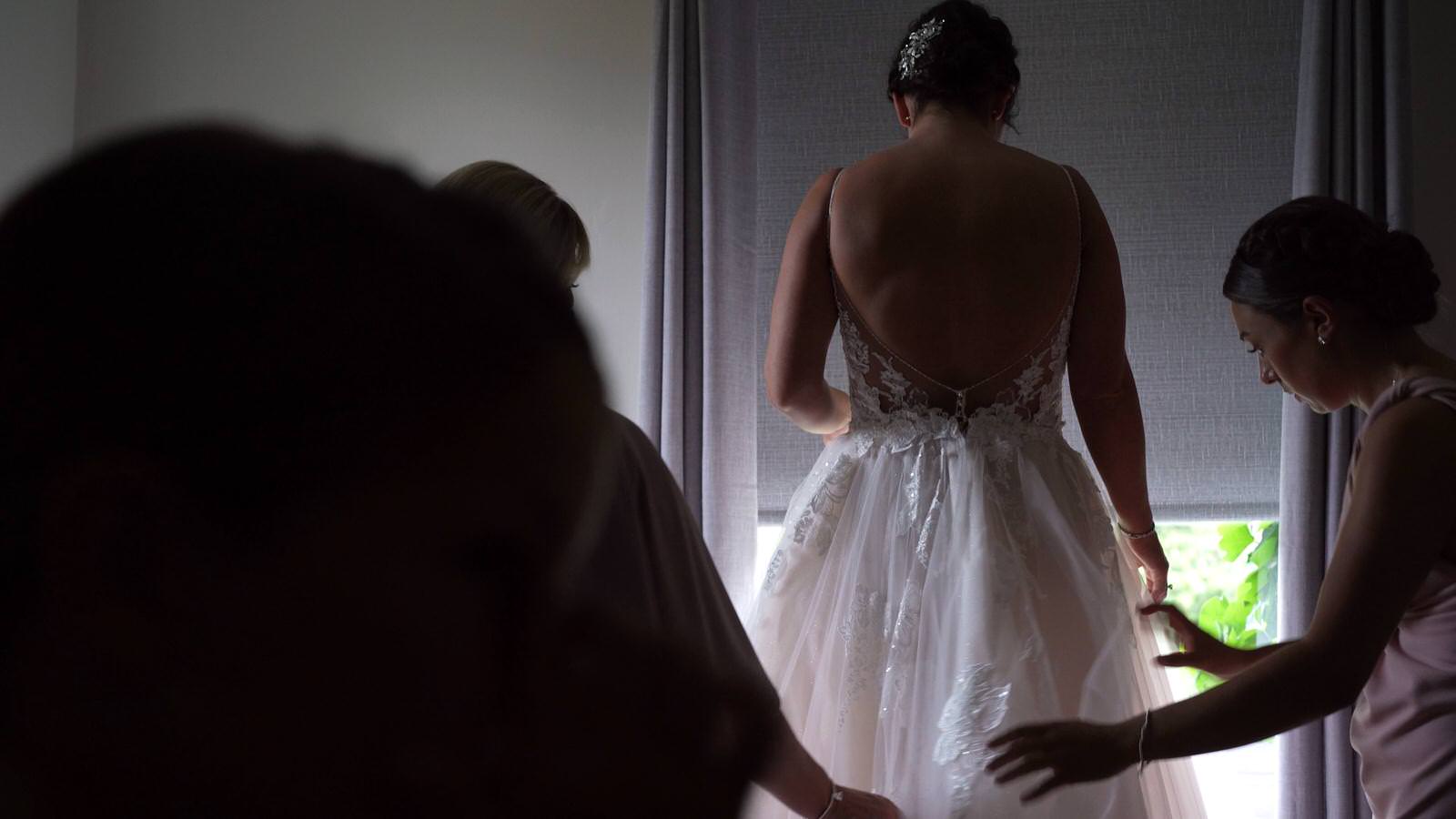 bride gets in to wedding dress at lock keepers cottage manchester