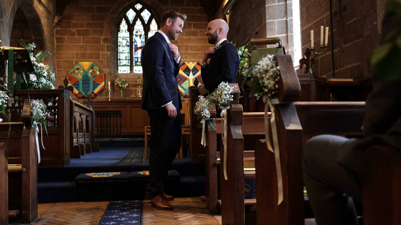 groom waits for ceremony at Burton village church