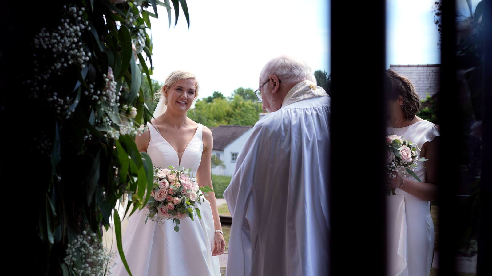 bride waits outside burton church