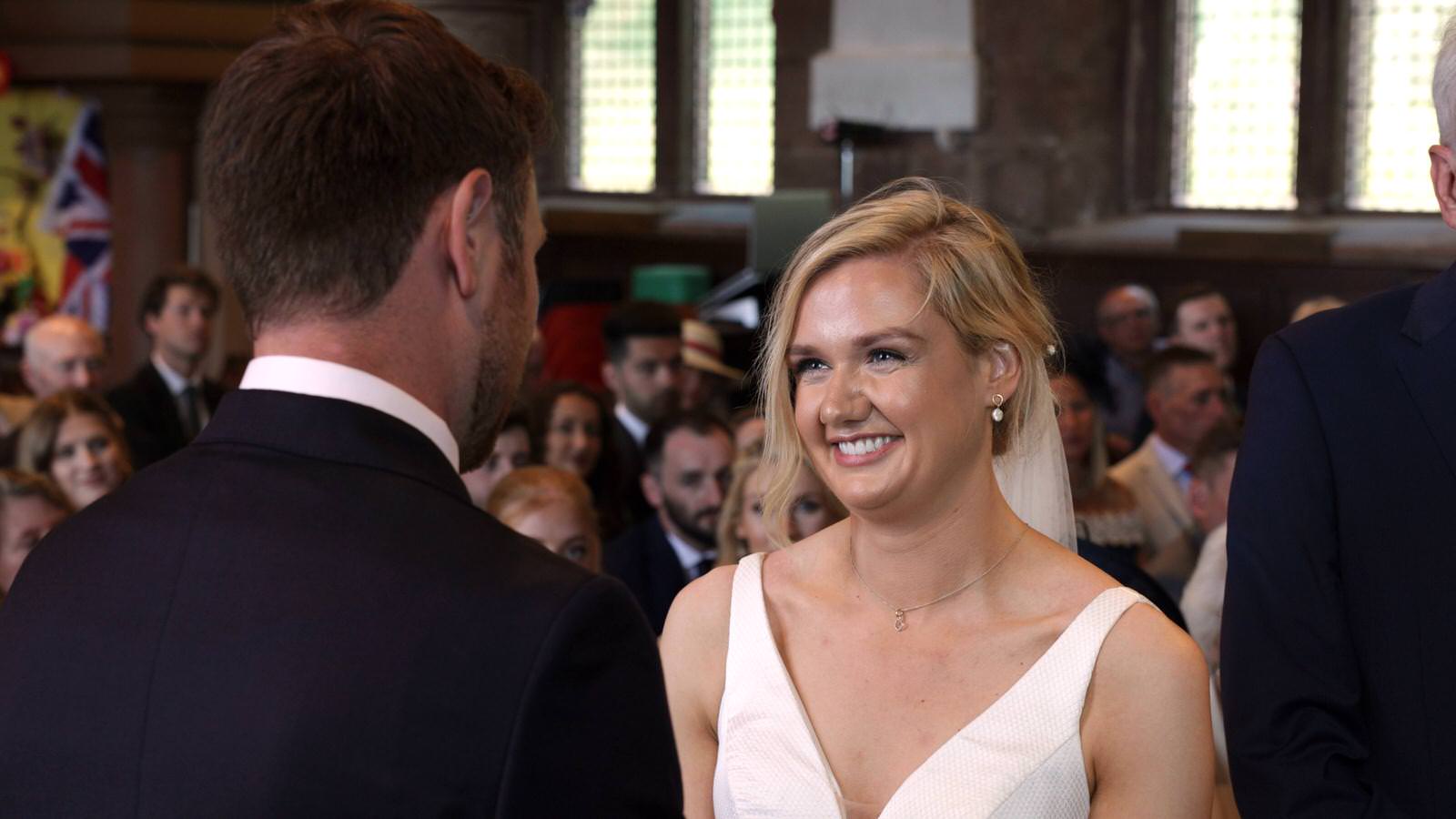 video of bride smiling at groom during ceremony