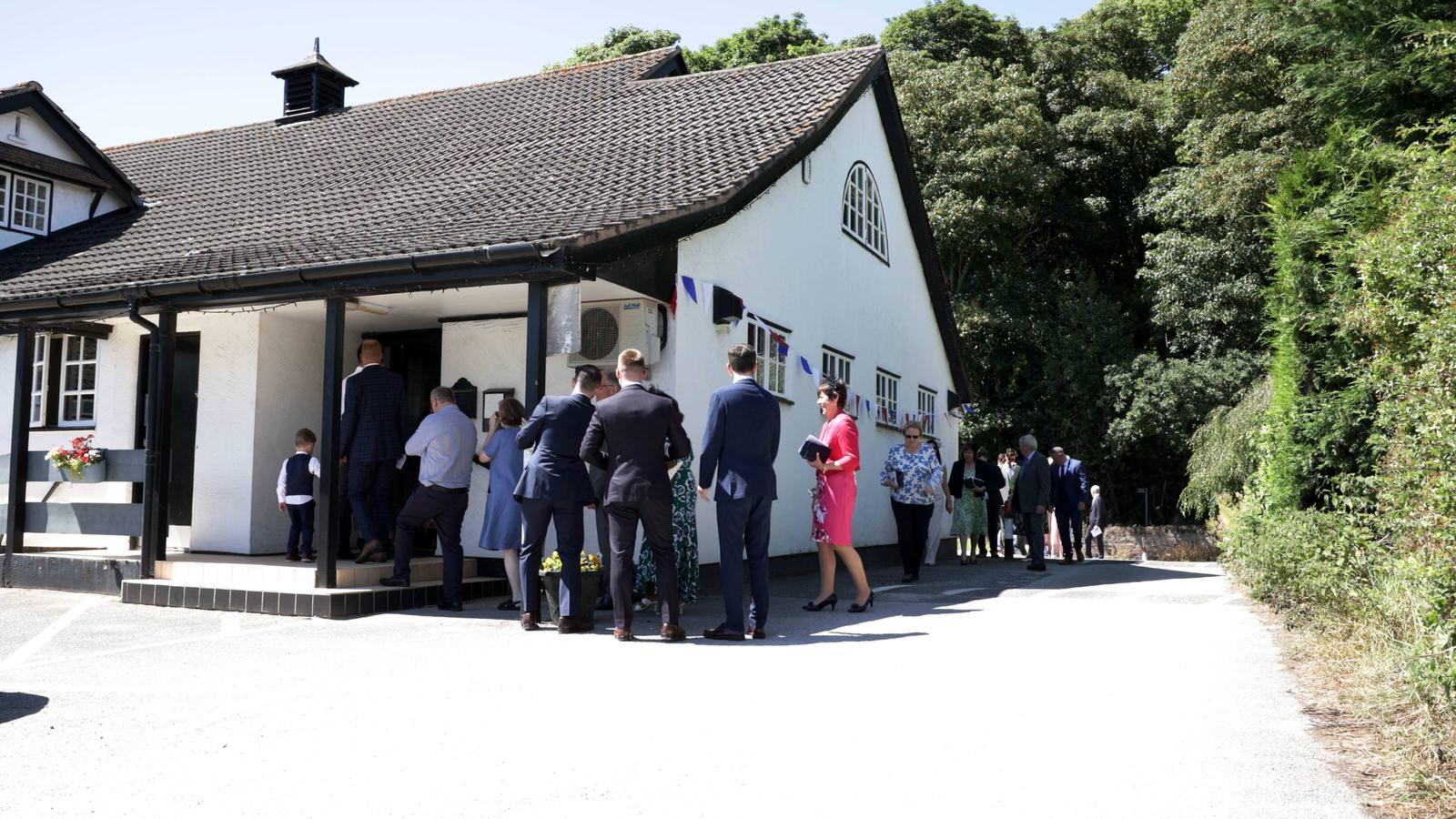 guests arrive at gladstone village hall wedding