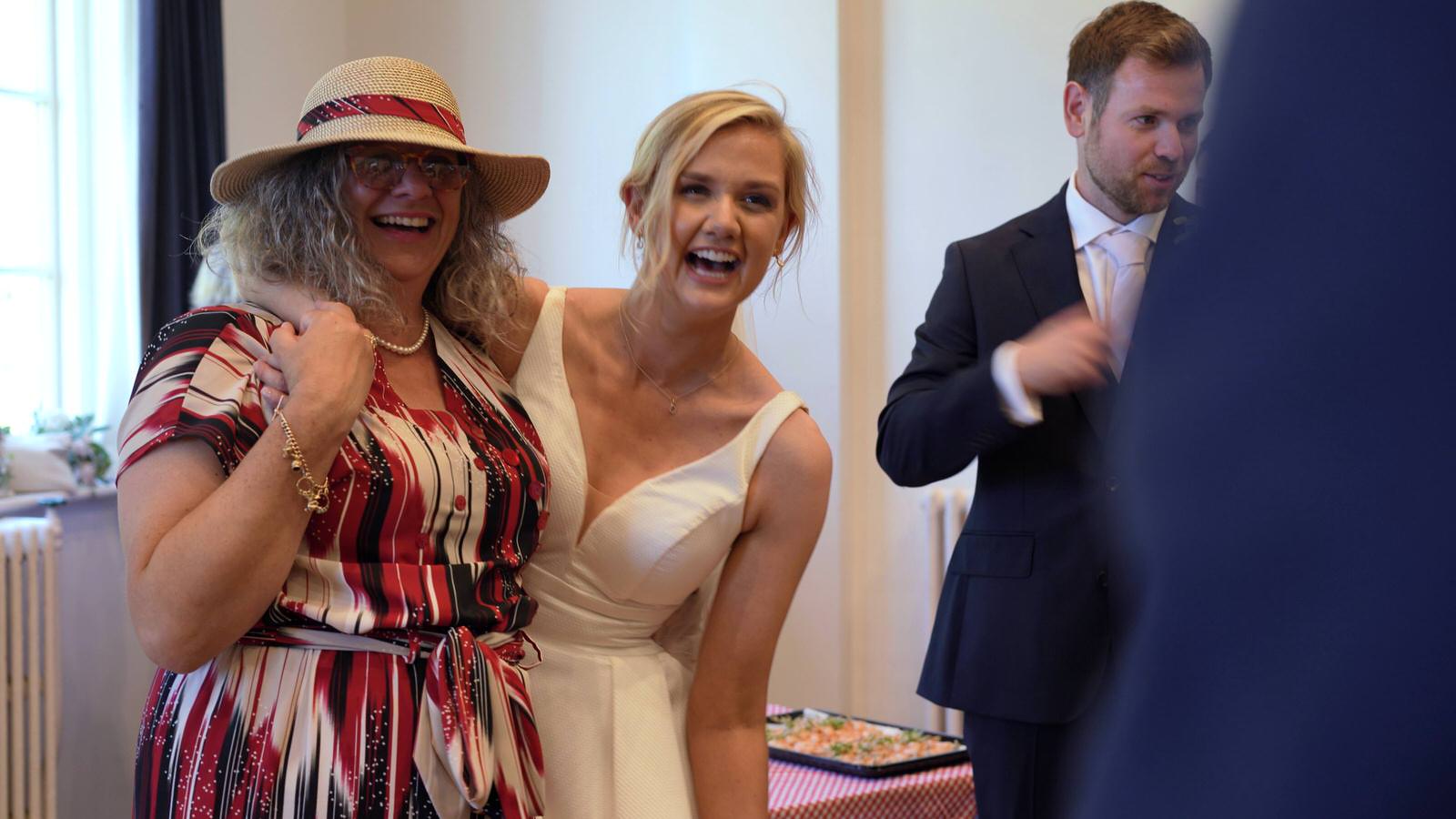bride laughs with guests at Gladstone village hall