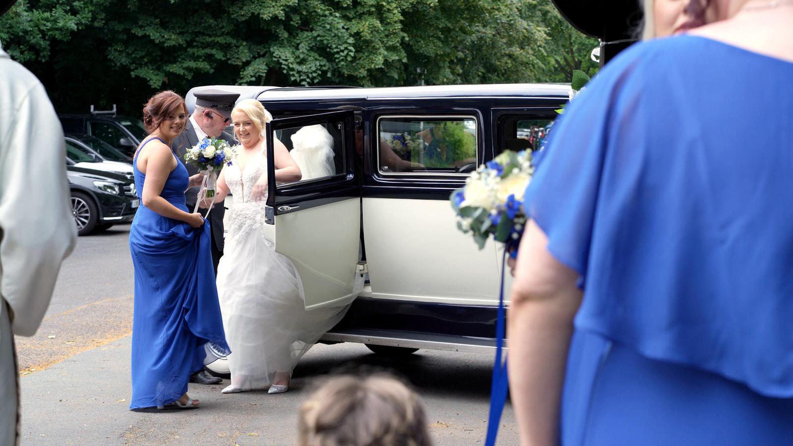 bride steps out of car outside church