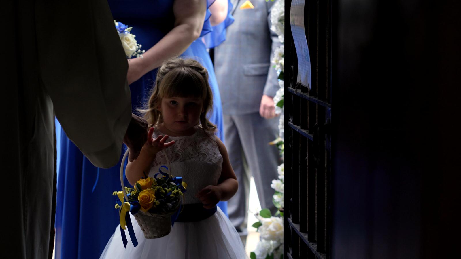 flower girl waiting in church doorway