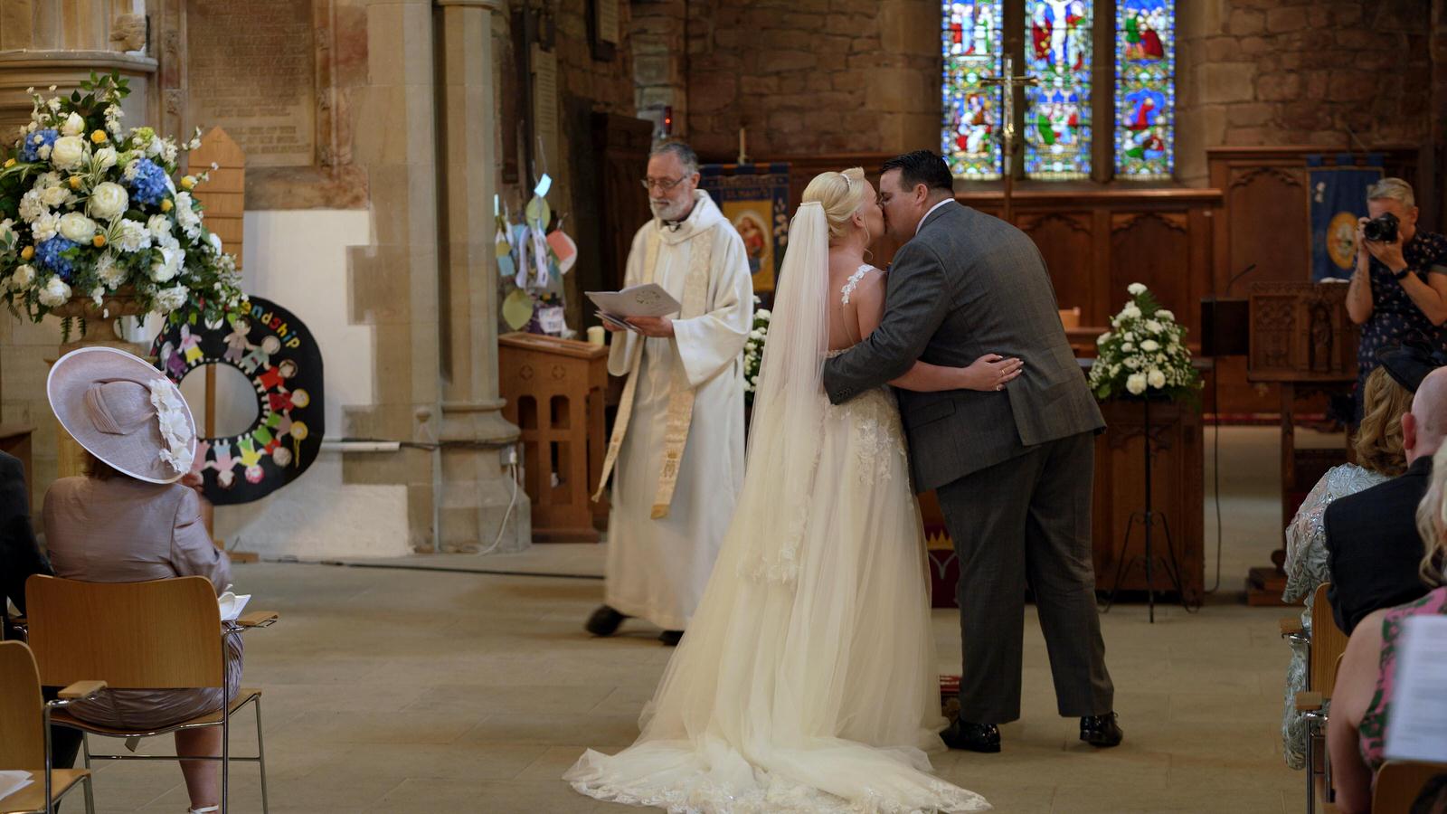 couple kiss at st marys church penwortham