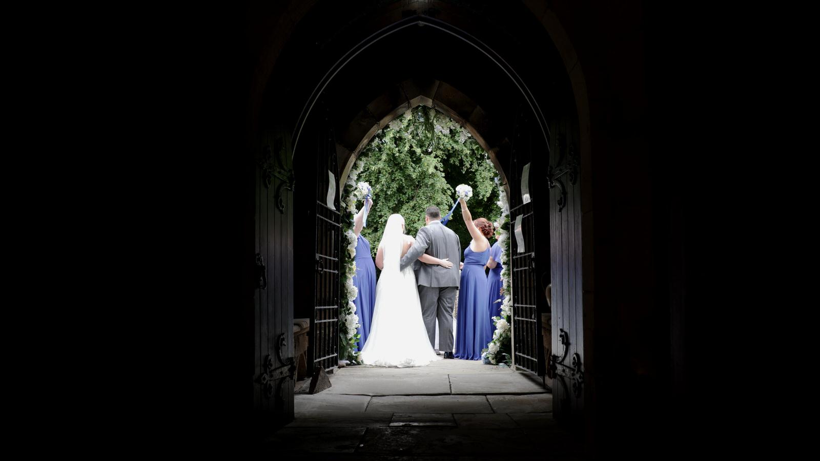 candid shot of wedding party outside st marys church penwortham