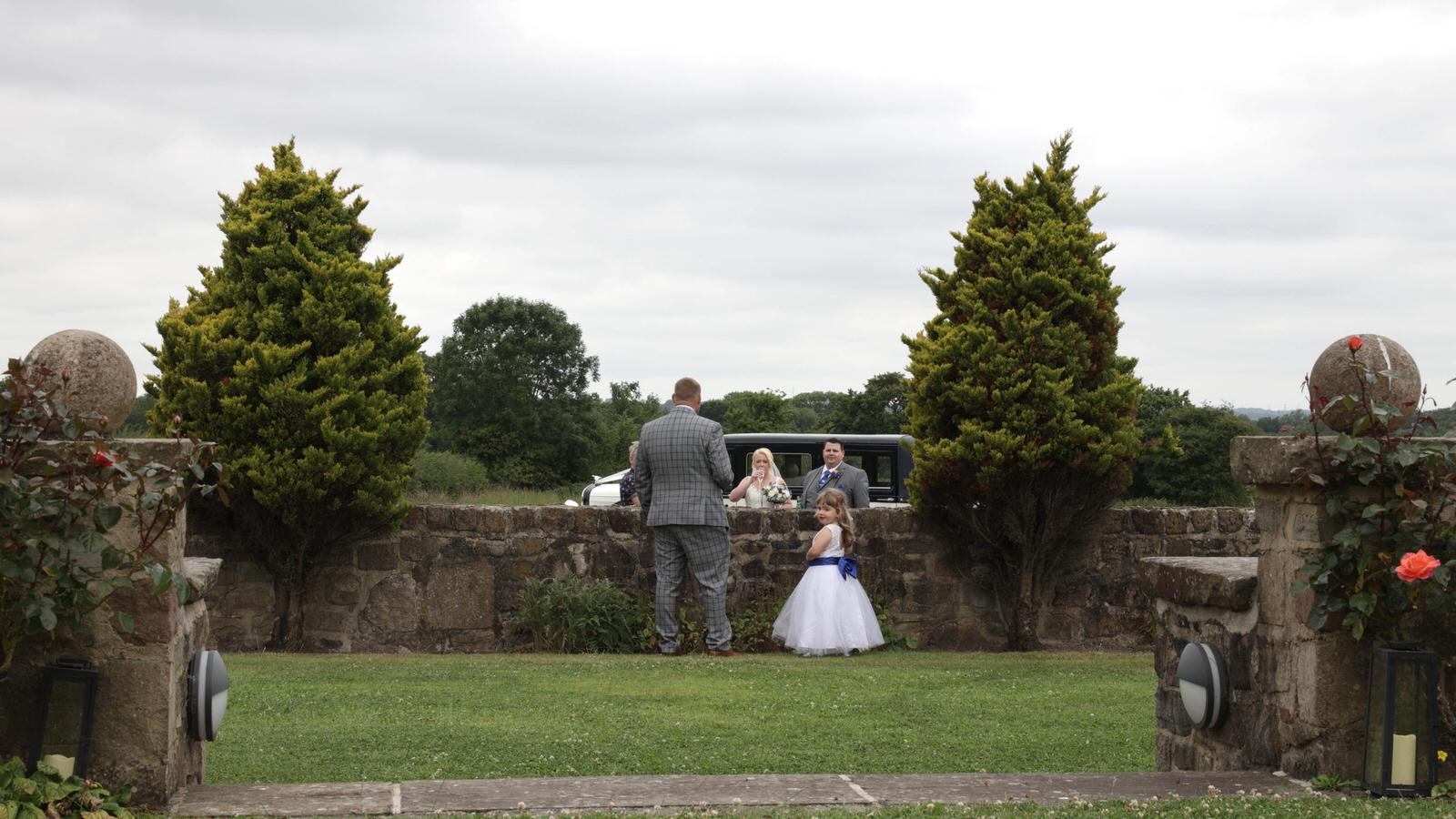 couple arrive in wedding car at Beeston Manor