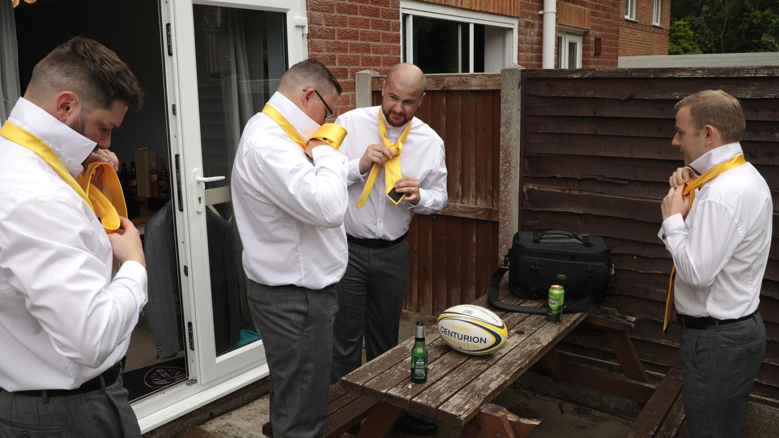 groomsman watching youtube for tie help