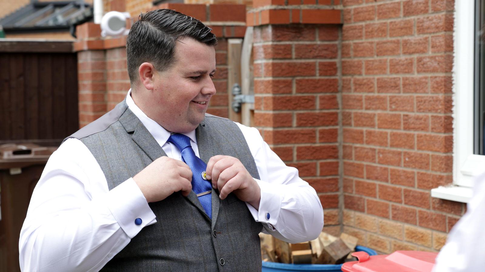 groom adds Leeds United pin to tie