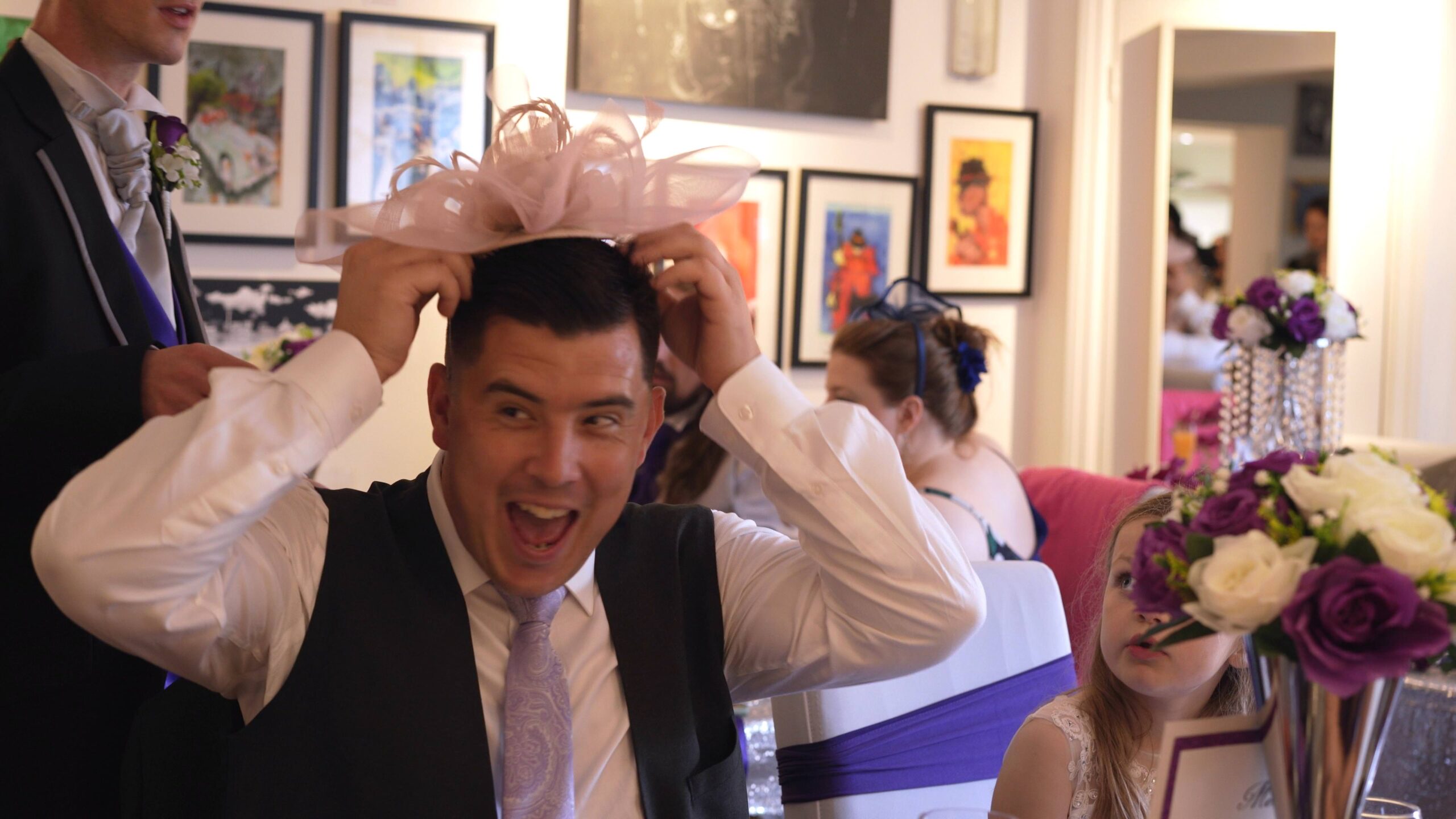 grooms brother laughs wearing mums fascinator