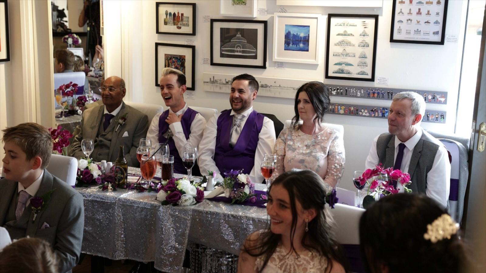 family laugh during wedding speeches