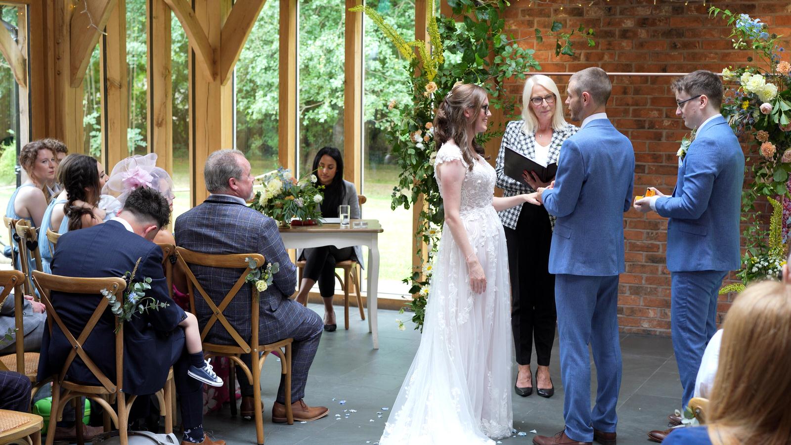 exchanging wedding rings at oaktree of peover wedding