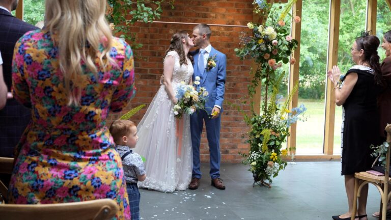 natural video still of couple kissing at oaktree of peover ceremony