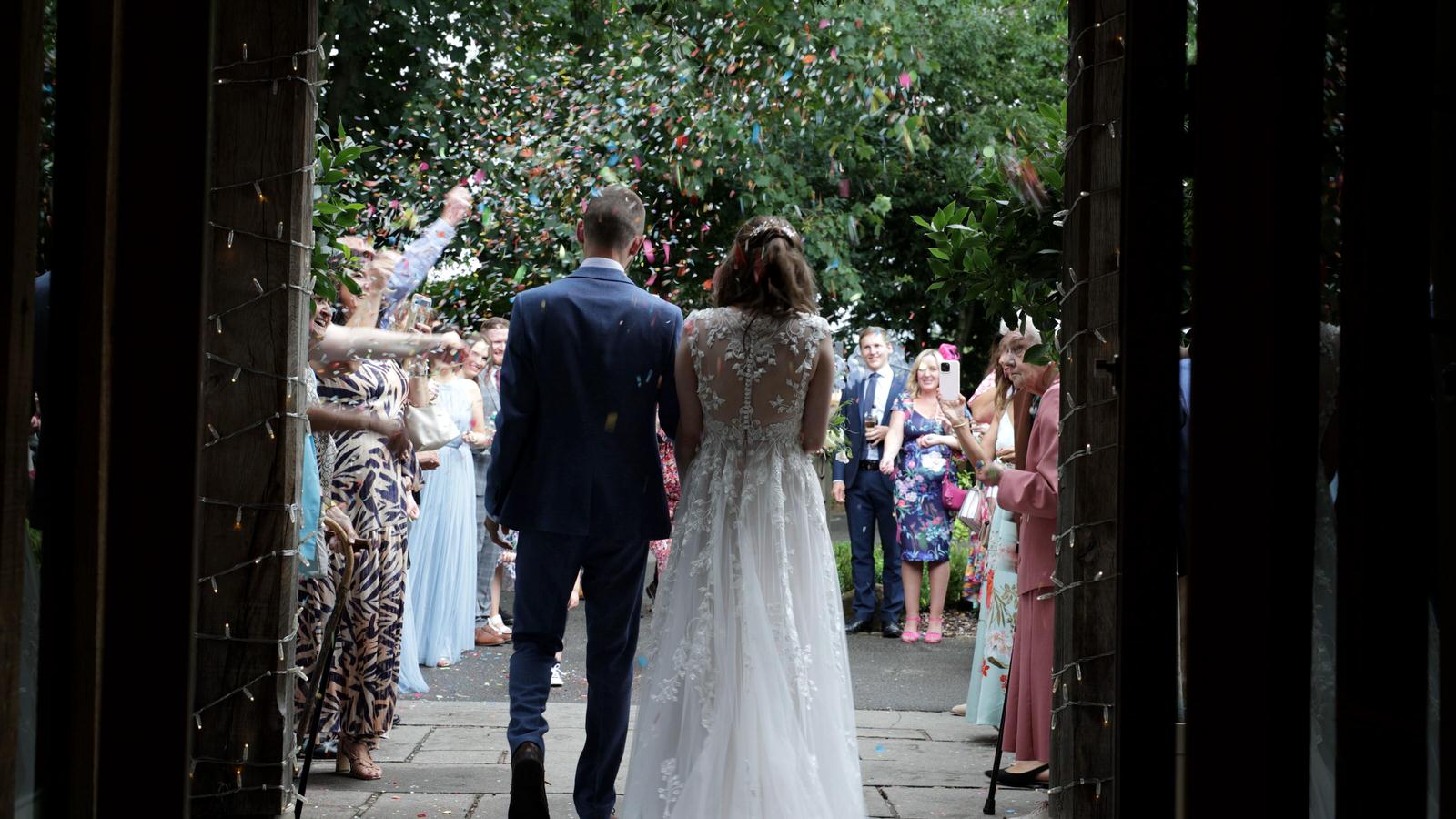 video still of confetti being thrown from behind couple