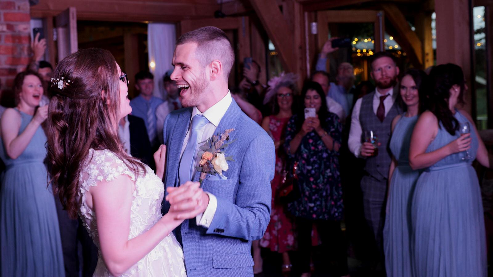 couple laugh during their first dance