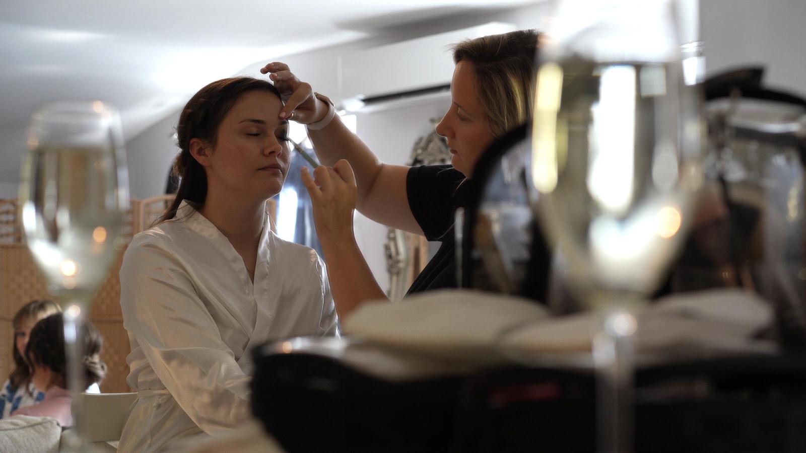 bride has her makeup done at Charnock farm