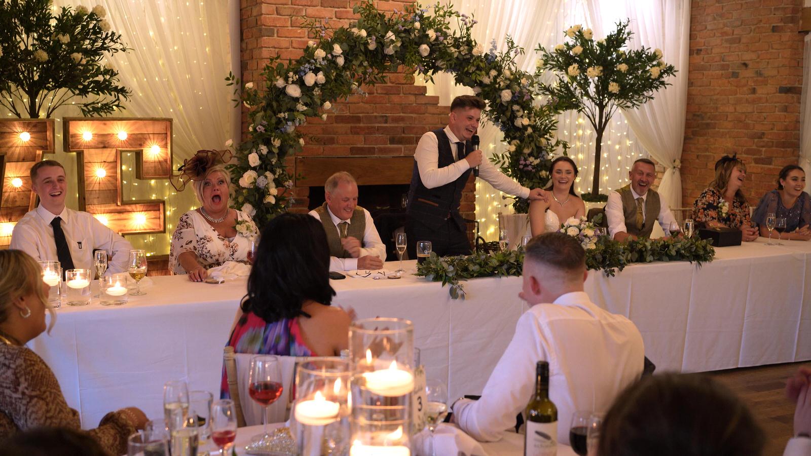 groom makes everyone laugh during speech