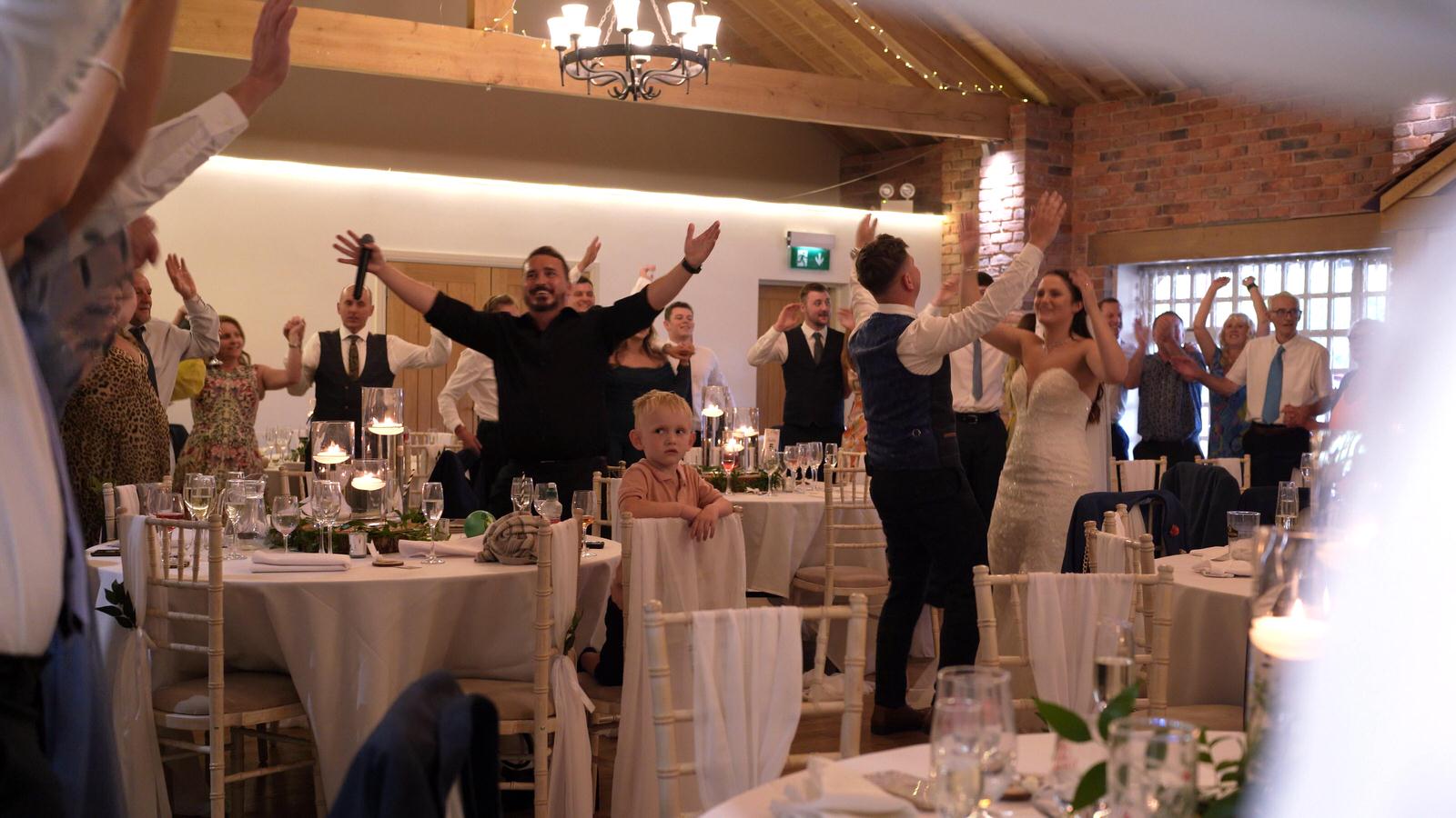 guests dancing along with the singing waiters at Charnock Farm