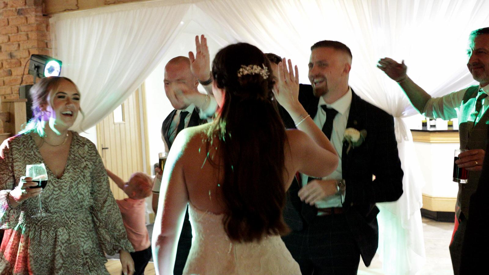 guests dance with the bride in the evening