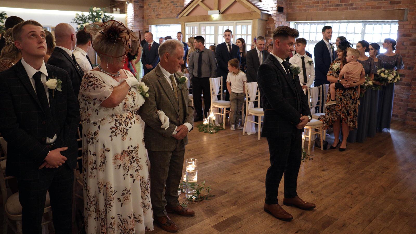 a groom waits before the ceremony at Charnock Farm