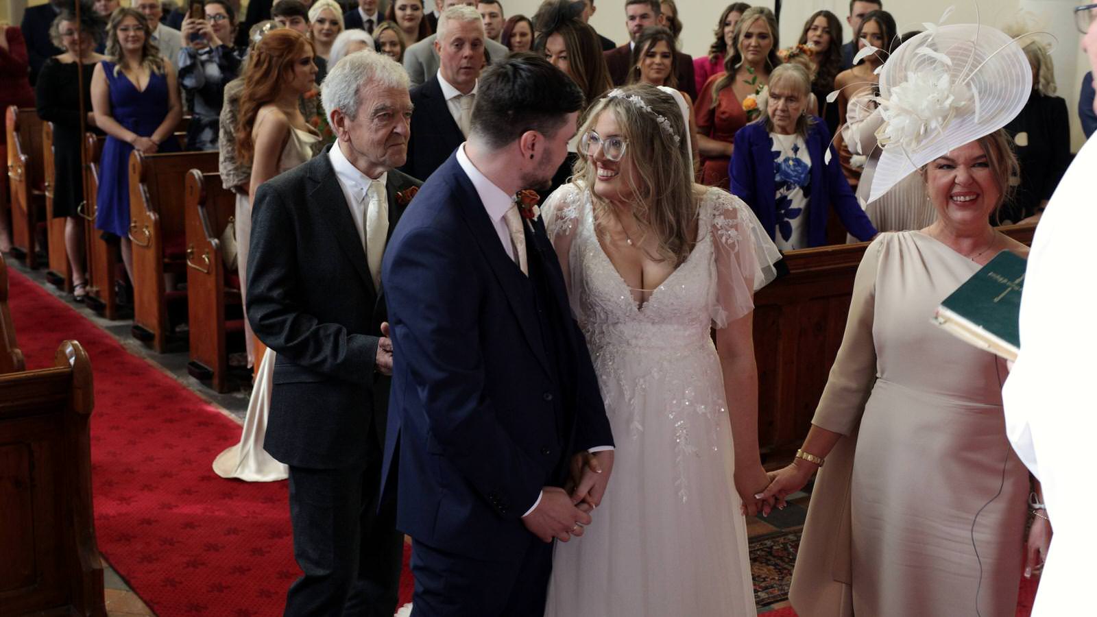 couple smile at each other at their wedding ceremony