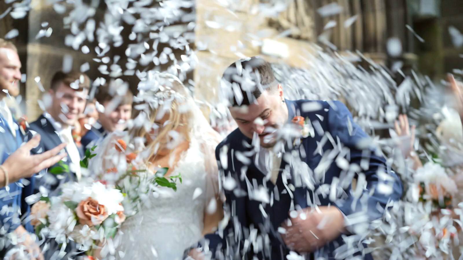 video still of so much white confetti outside holy trinity church