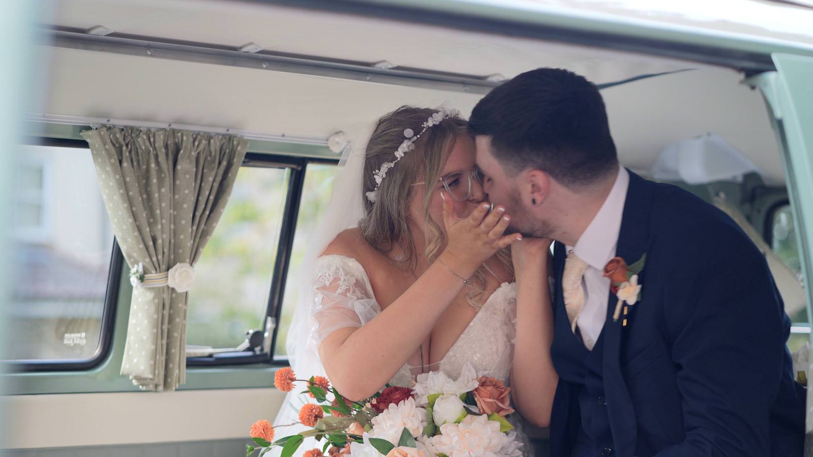 couple kiss in vintage campervan