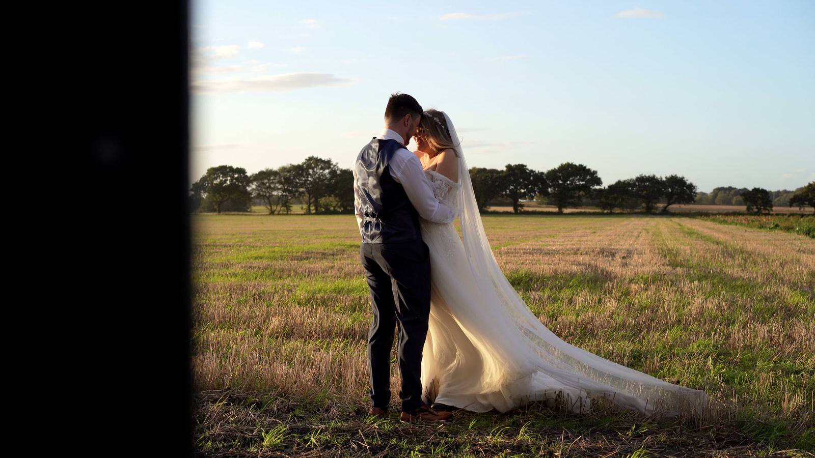 couple snuggle during the golden hour in Lancashire