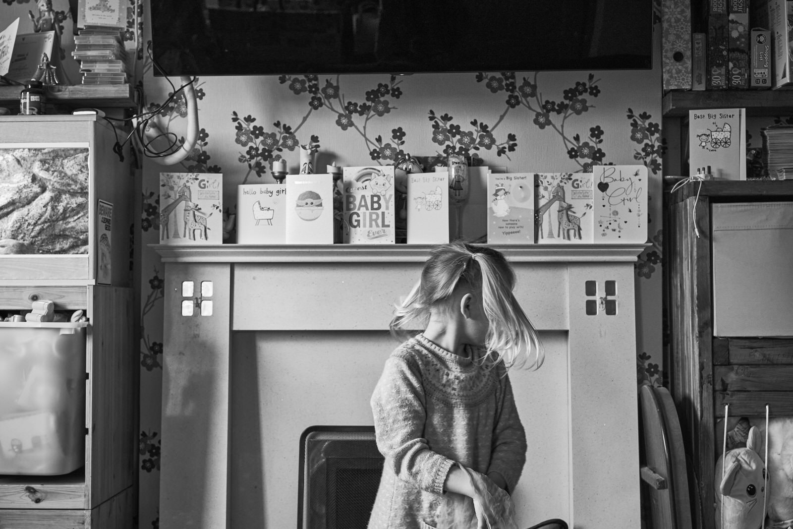 natural photo of a girl dancing in front of newborn baby cards