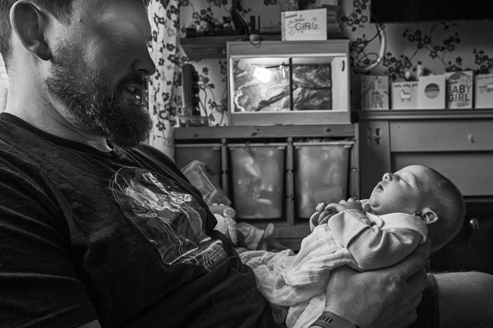 dad holds baby in his hands during family photoshoot