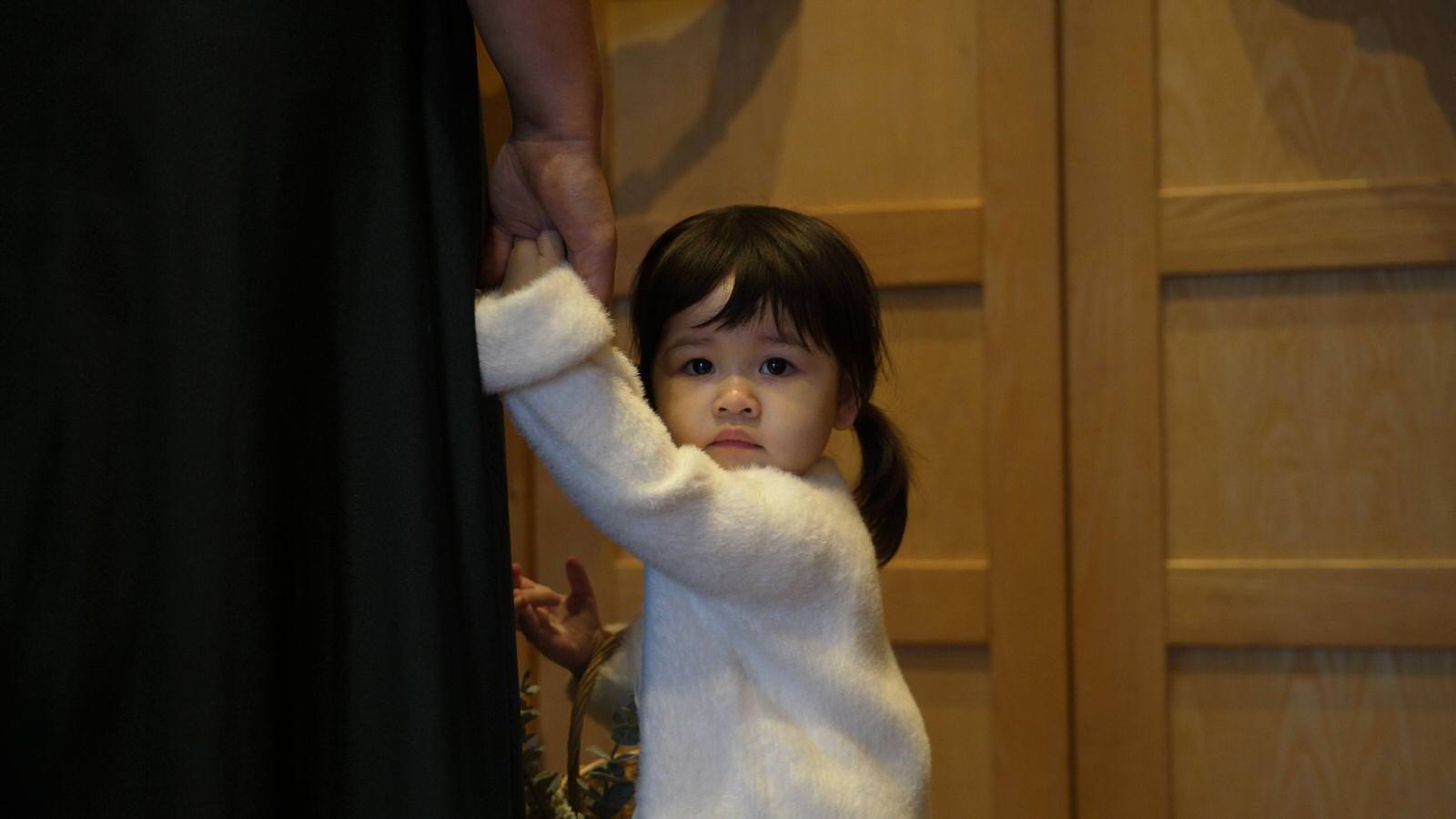 flowergirl looks back at wedding videographer