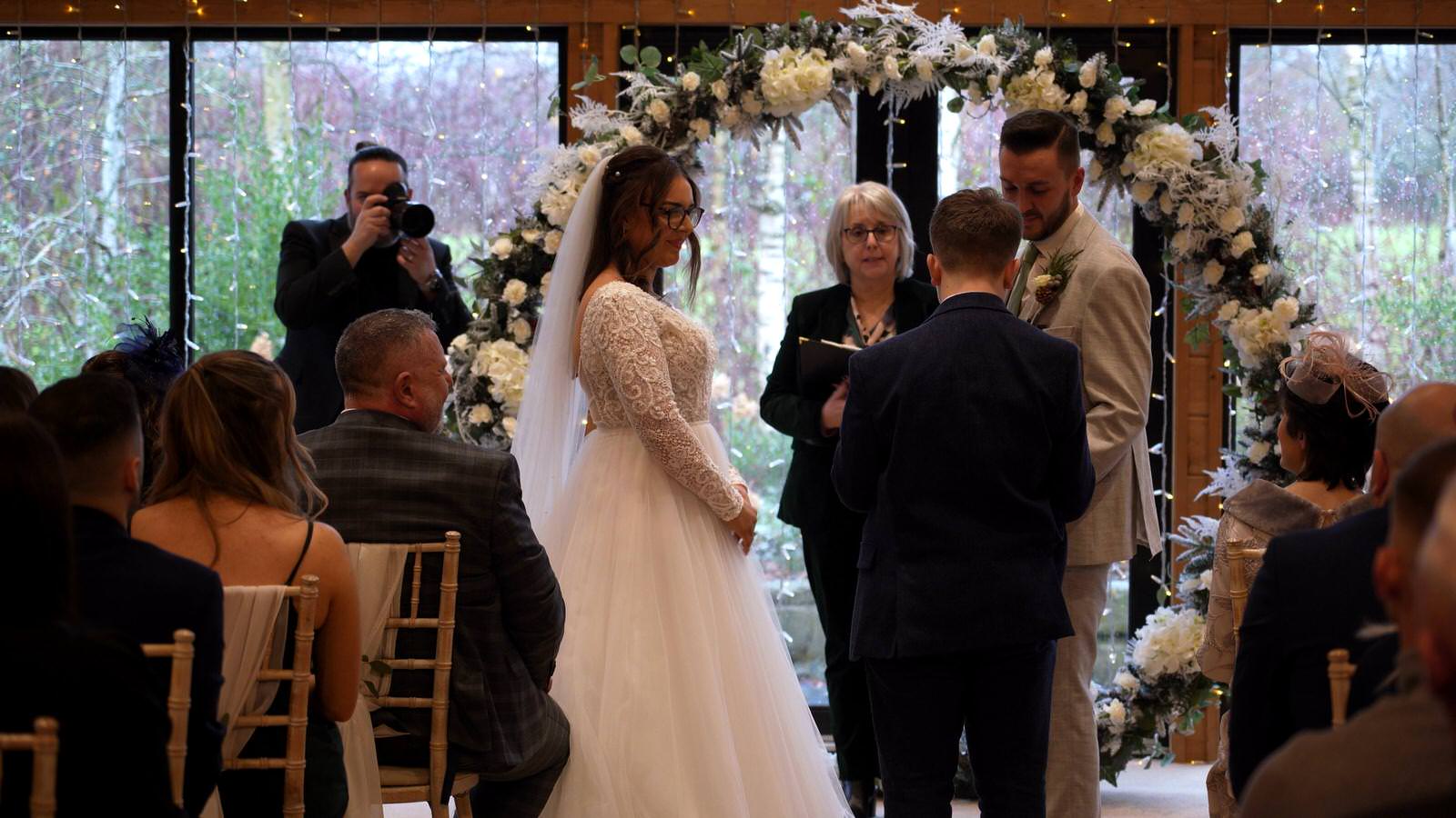 ring barer gives the couple their rings at Styal Lodge
