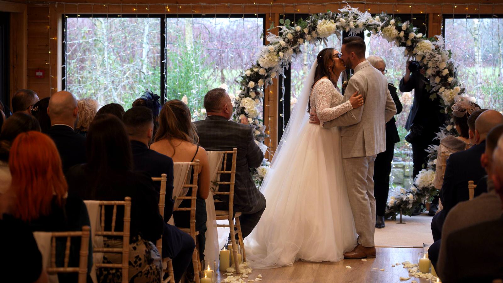 couple kiss during Styal Lodge wedding ceremony