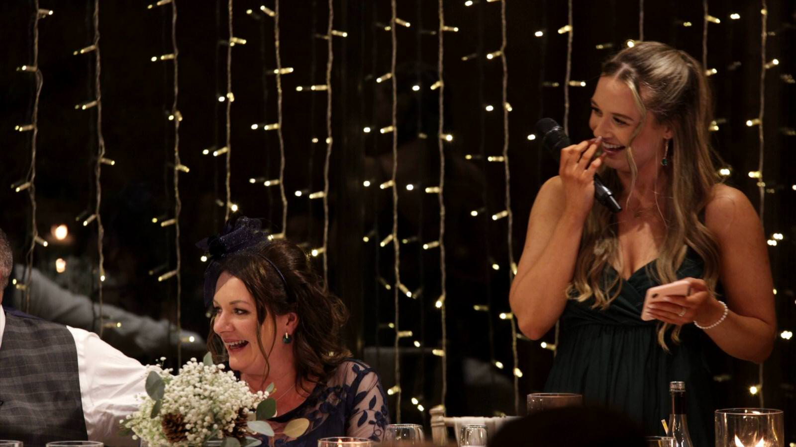 bridesmaid laughs during wedding speech