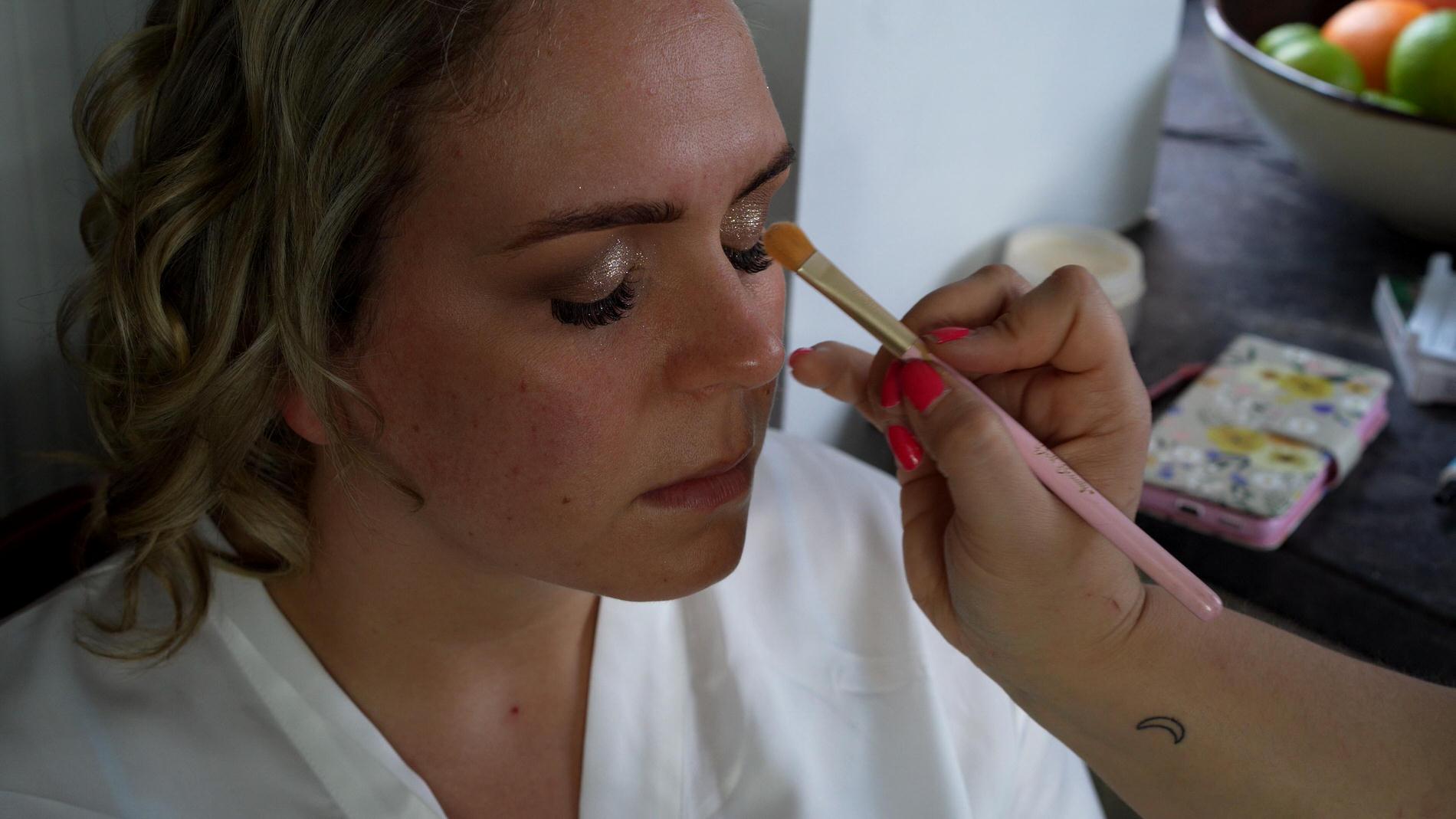 a bride gets her eye makeup done