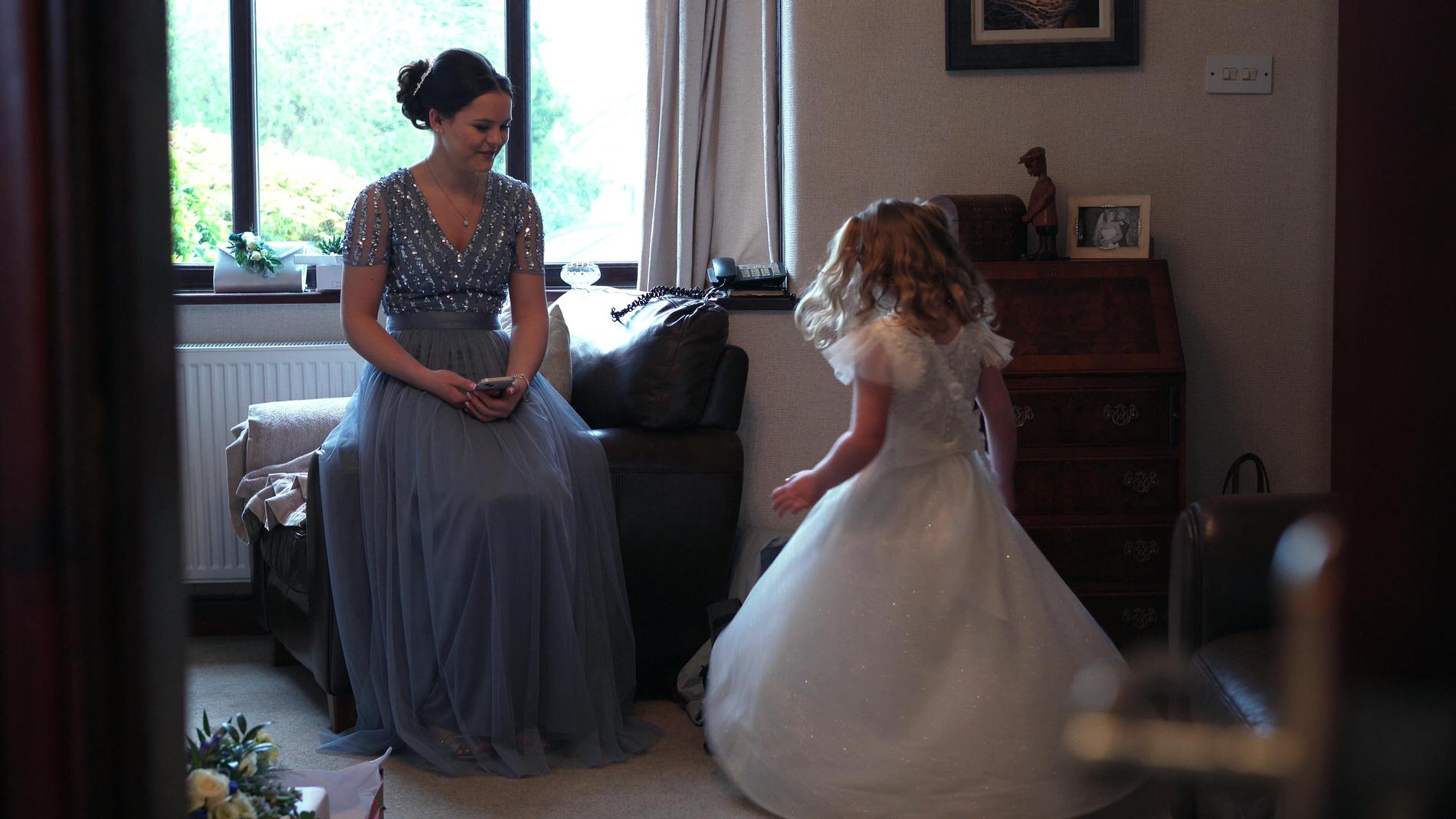 a flower girl twirls in her dress
