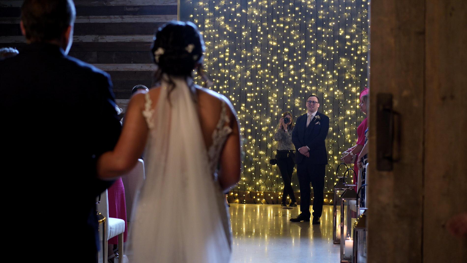 bride walks down the aisle at Wharfdale Grange in Yorkshire