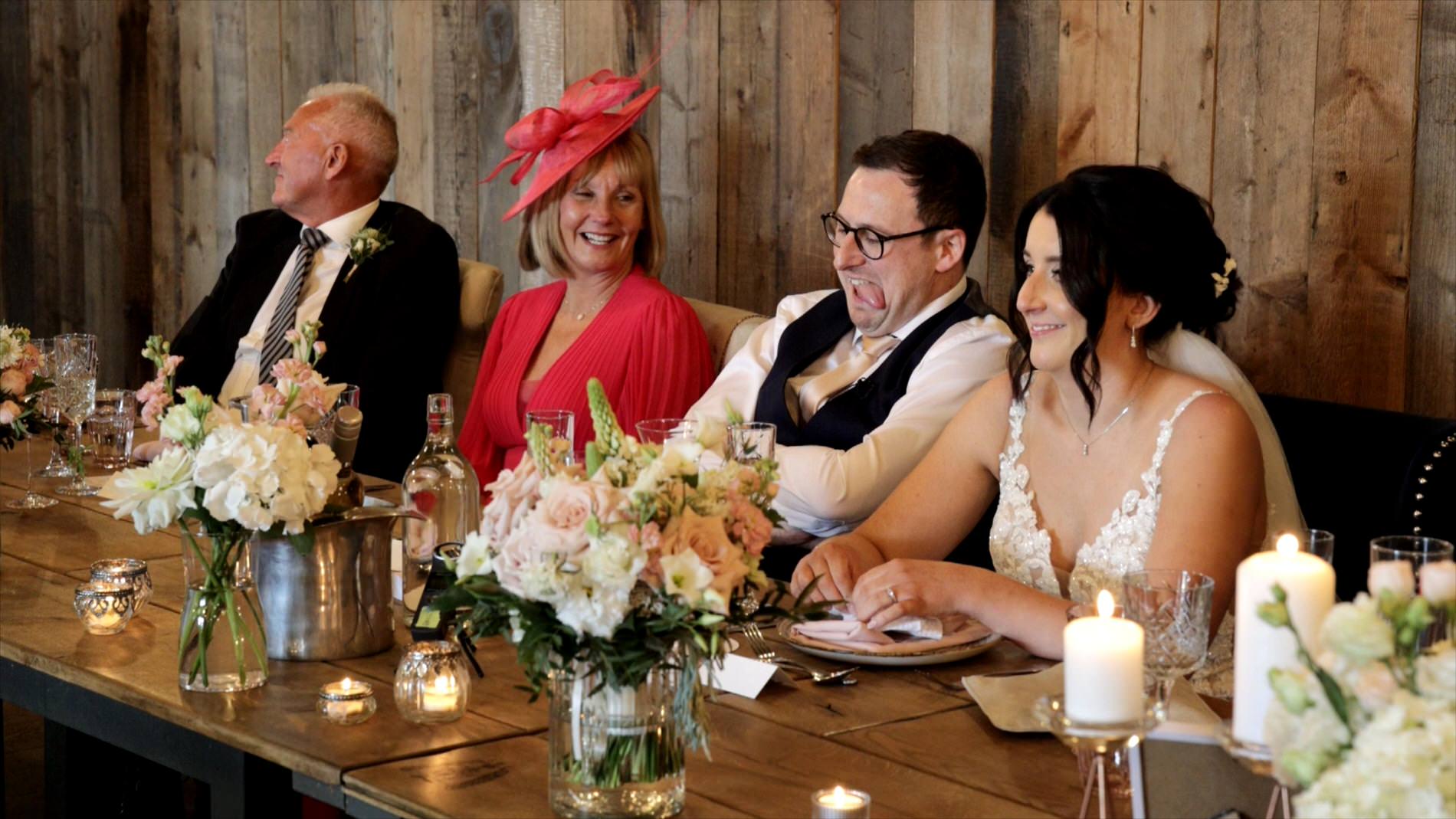 a groom looks embarrassed during best man speech