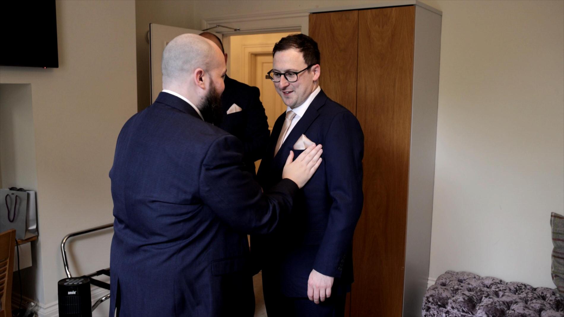 groom has his pocket square fixed