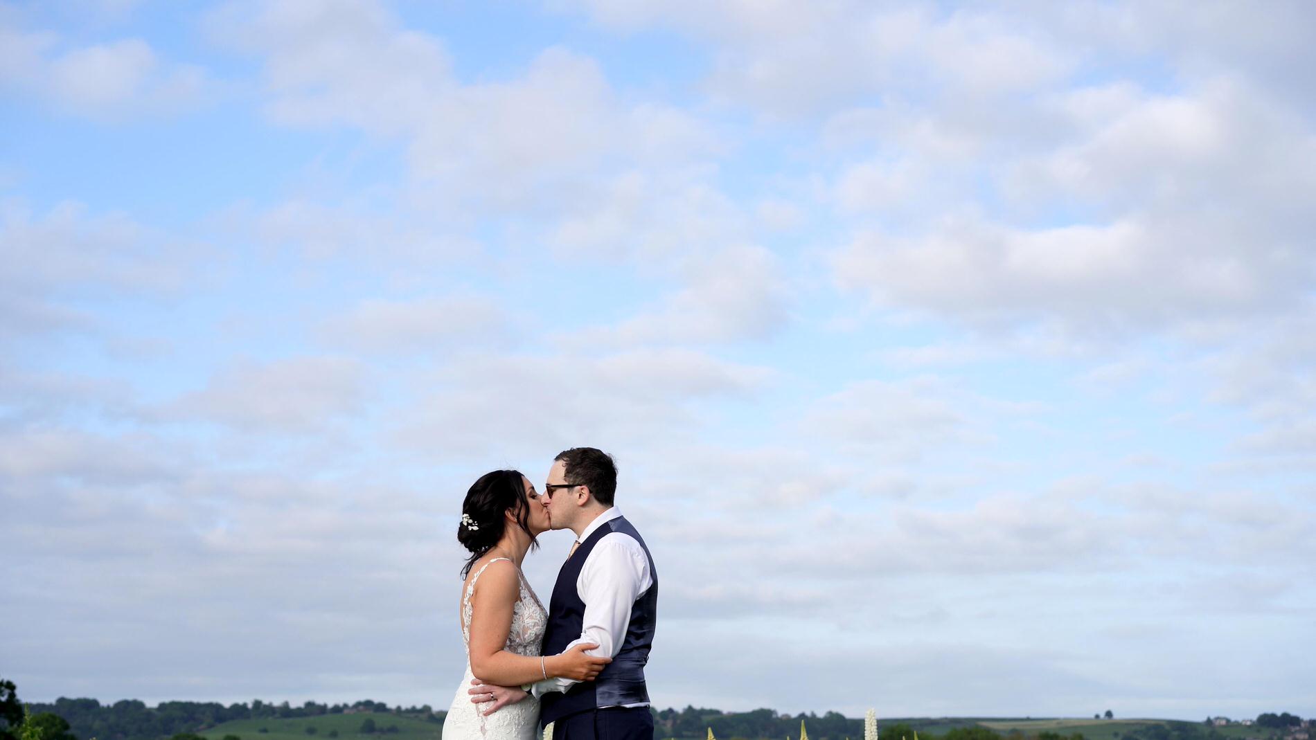 couple pose under a bright blue sky in Yorkshire