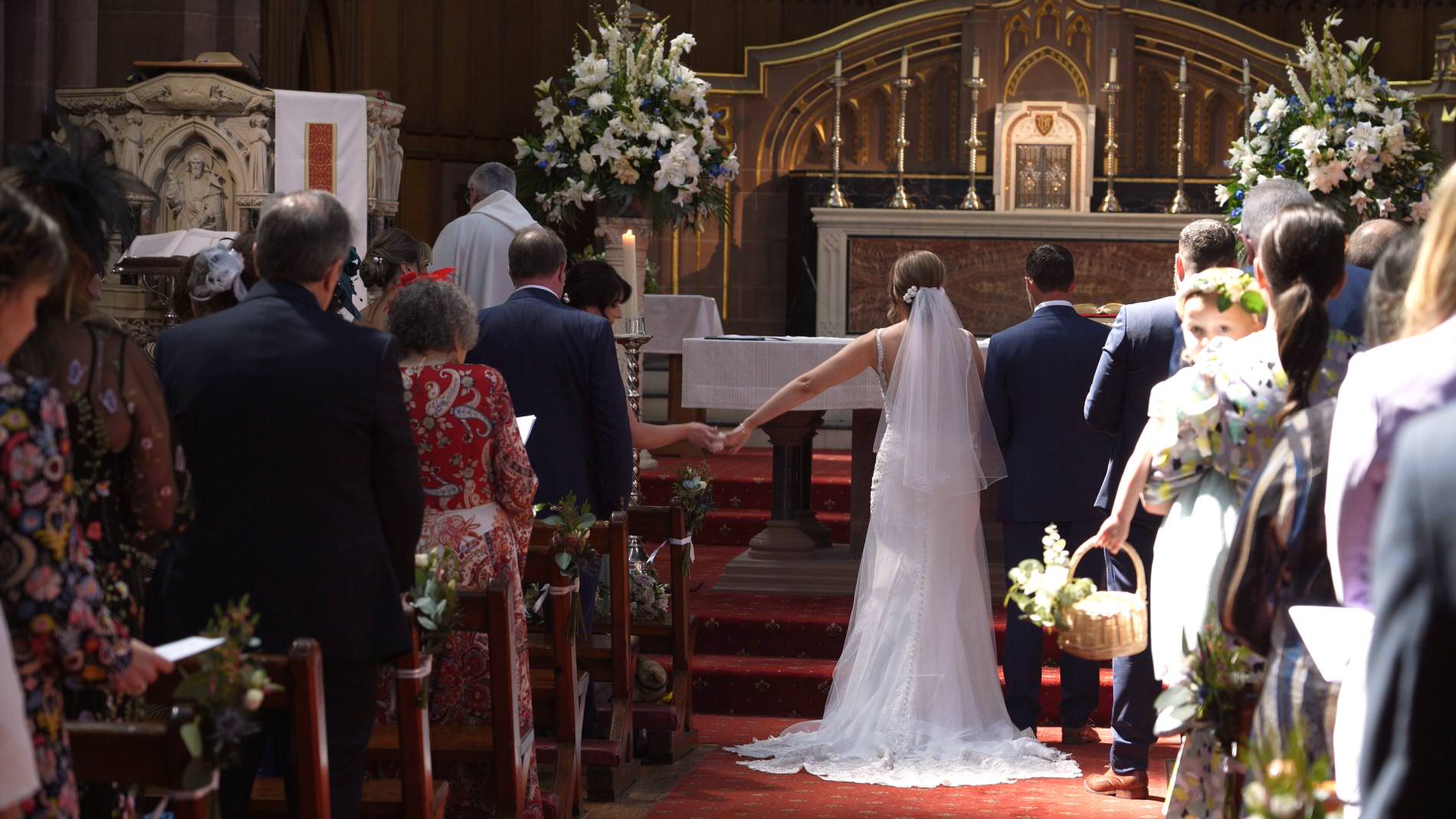 bride reaches out for a tissue during the wedding ceremony