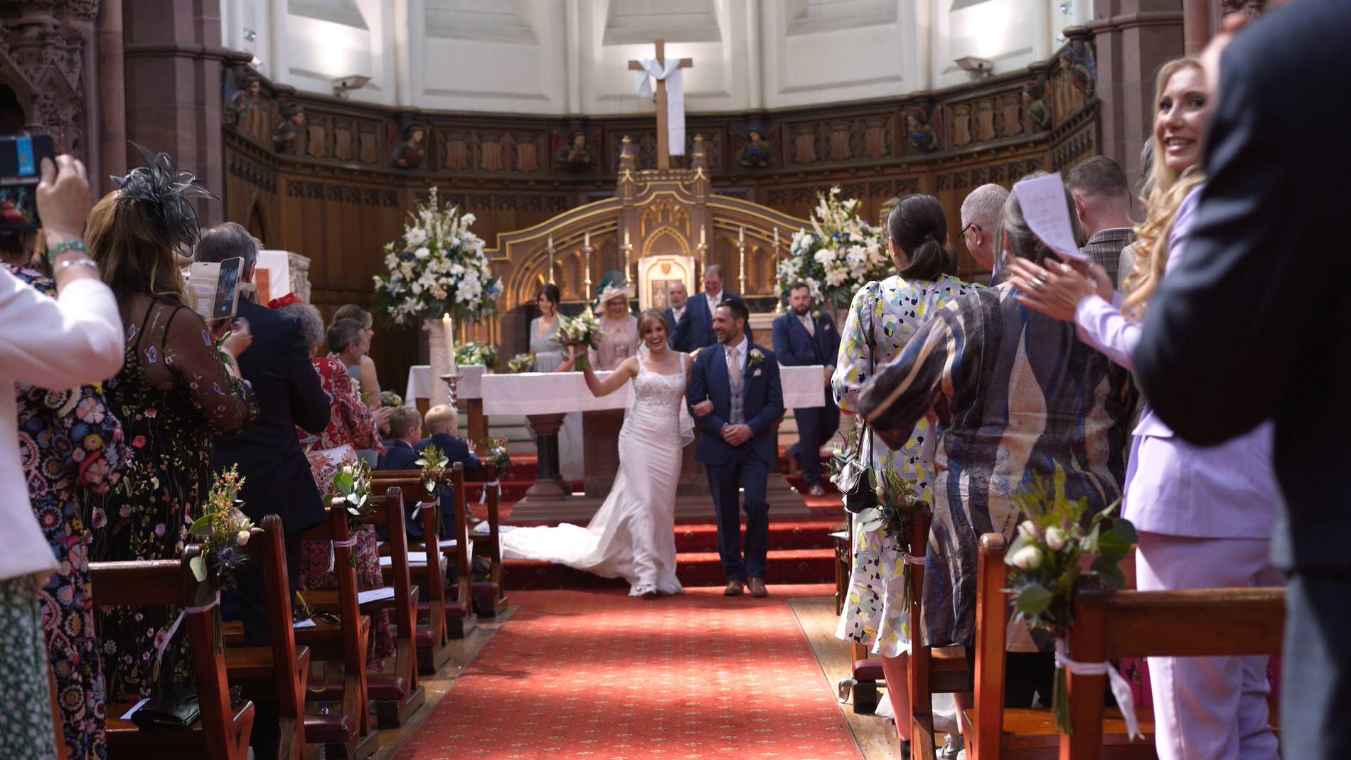 couple dance down the aisle during St Werburgh's Church wedding